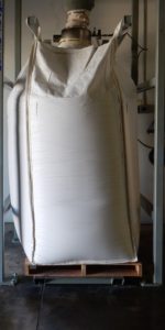 large white bulk bag on wooden pallet in warehouse